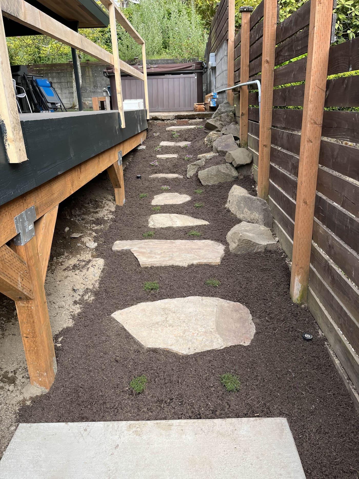 Rectangular stepping stone pathway along a driveway in Greater Seattle